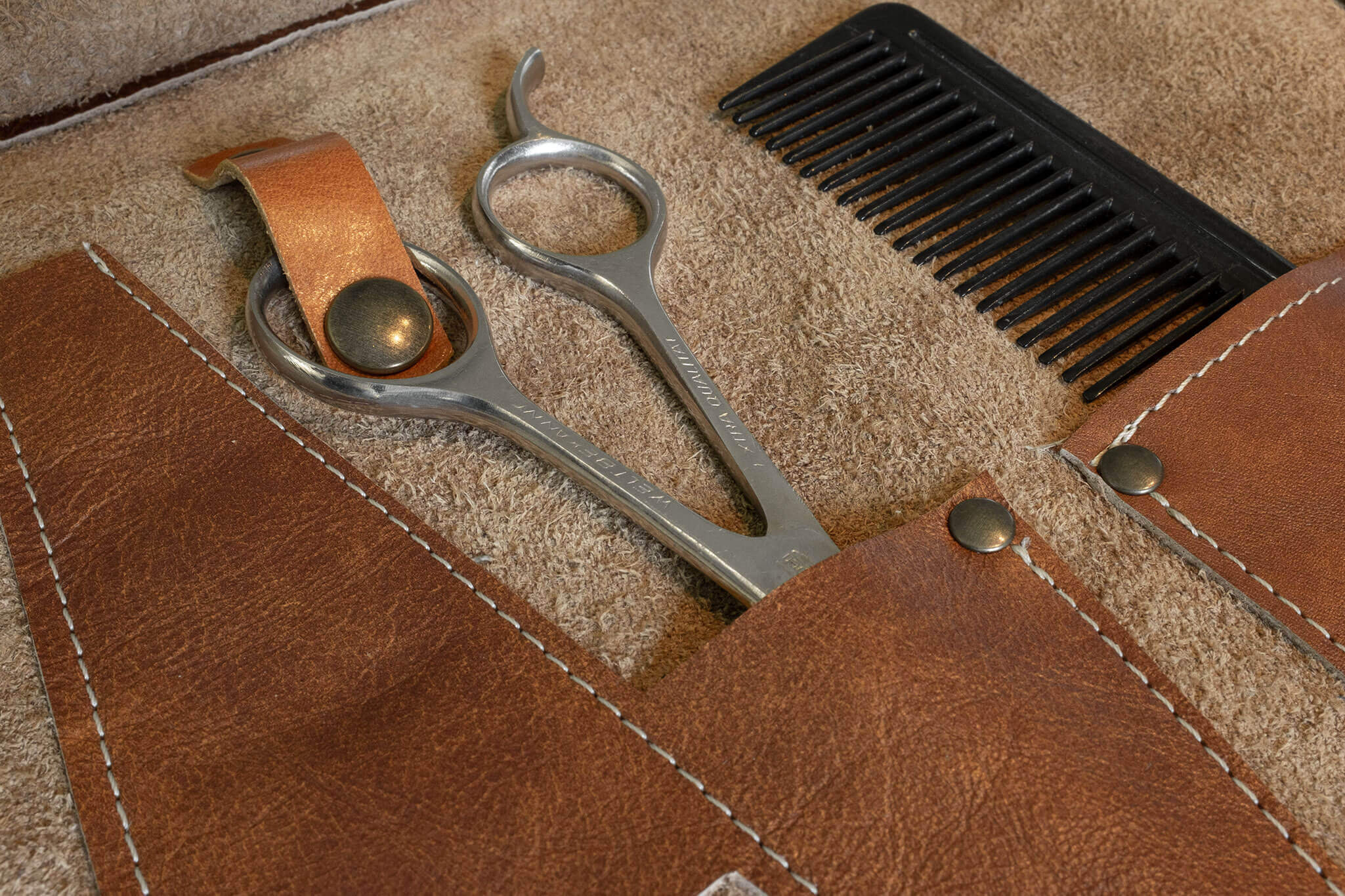 Duke and Sons Professional barber tool roll in cognac leather, secured scissor pocket close-up