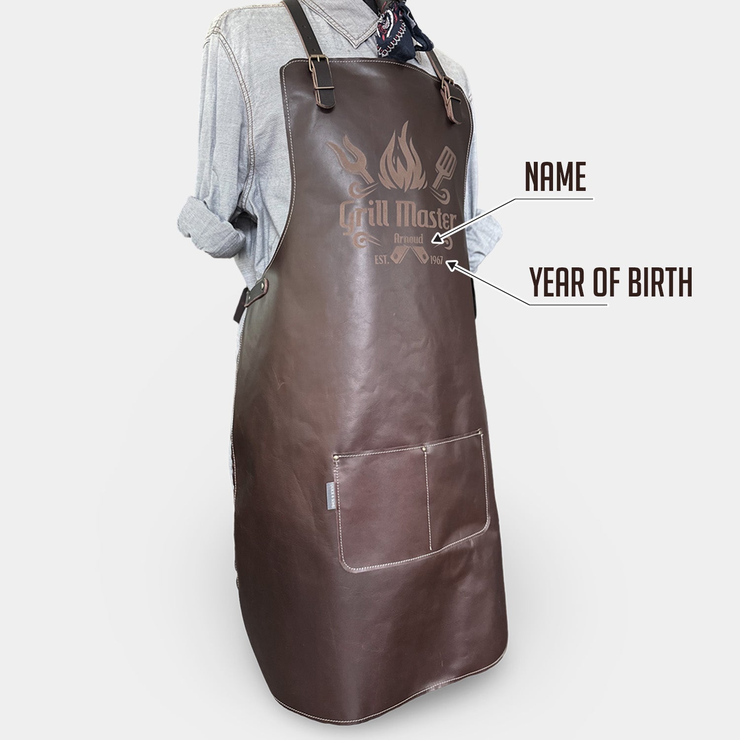 Brown apron with 'Grill Master' branding on a light gray background