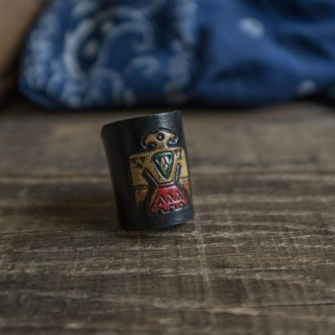 Woggle, bandana / neckerchief slide made from leather with a native eagle symbol image stamp, close up