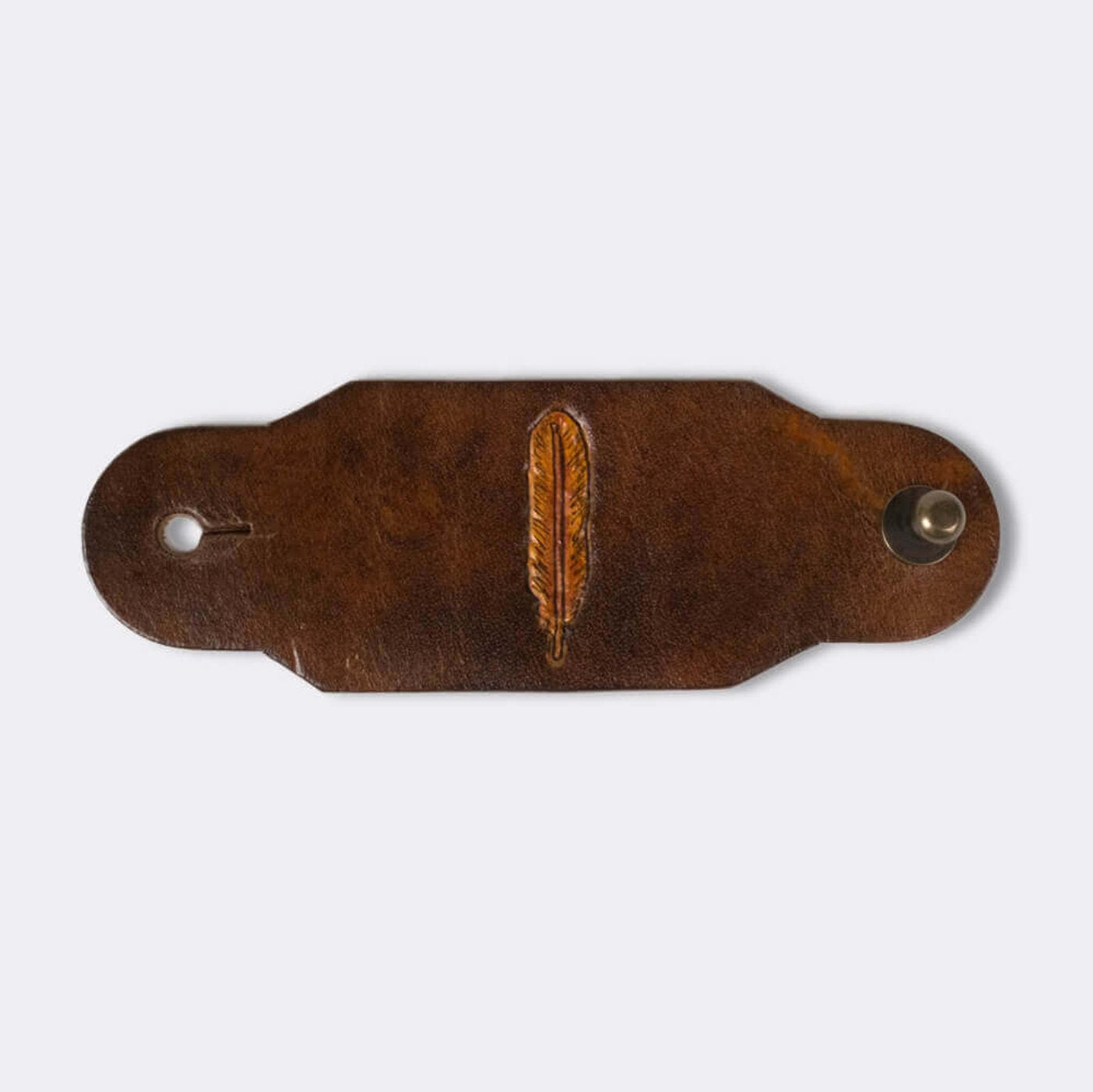 Woggle, bandana / neckerchief slide made from brown leather with a feather image stamp