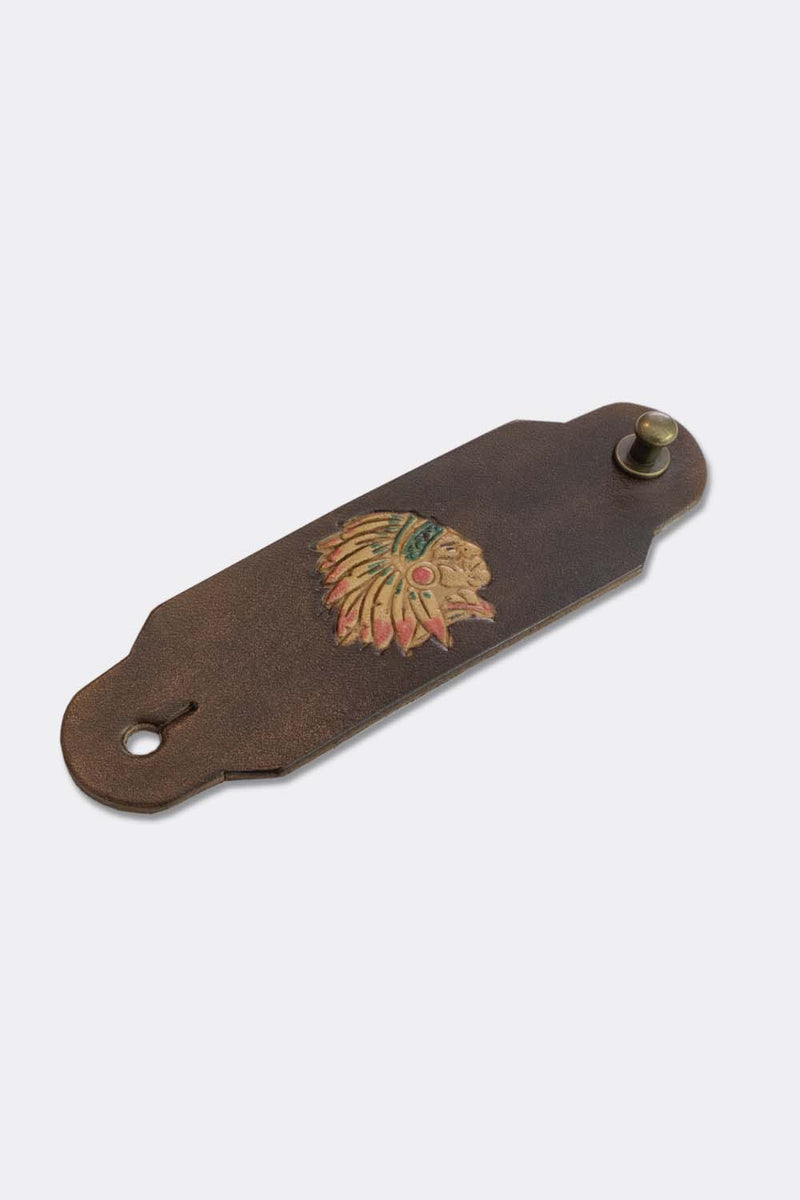 Woggle, bandana / neckerchief slide made from brown leather with an Indian Chief image stamp, slanted view