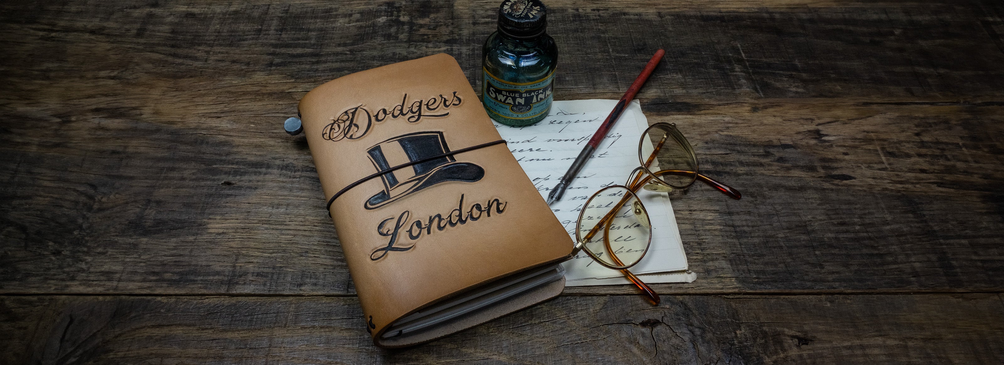 handmade leather traveller notebook with handembossed image and text