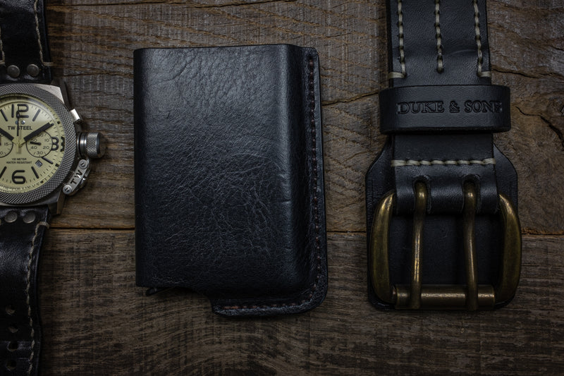Duke and Sons black RFID protected wallet with belt and watch scene