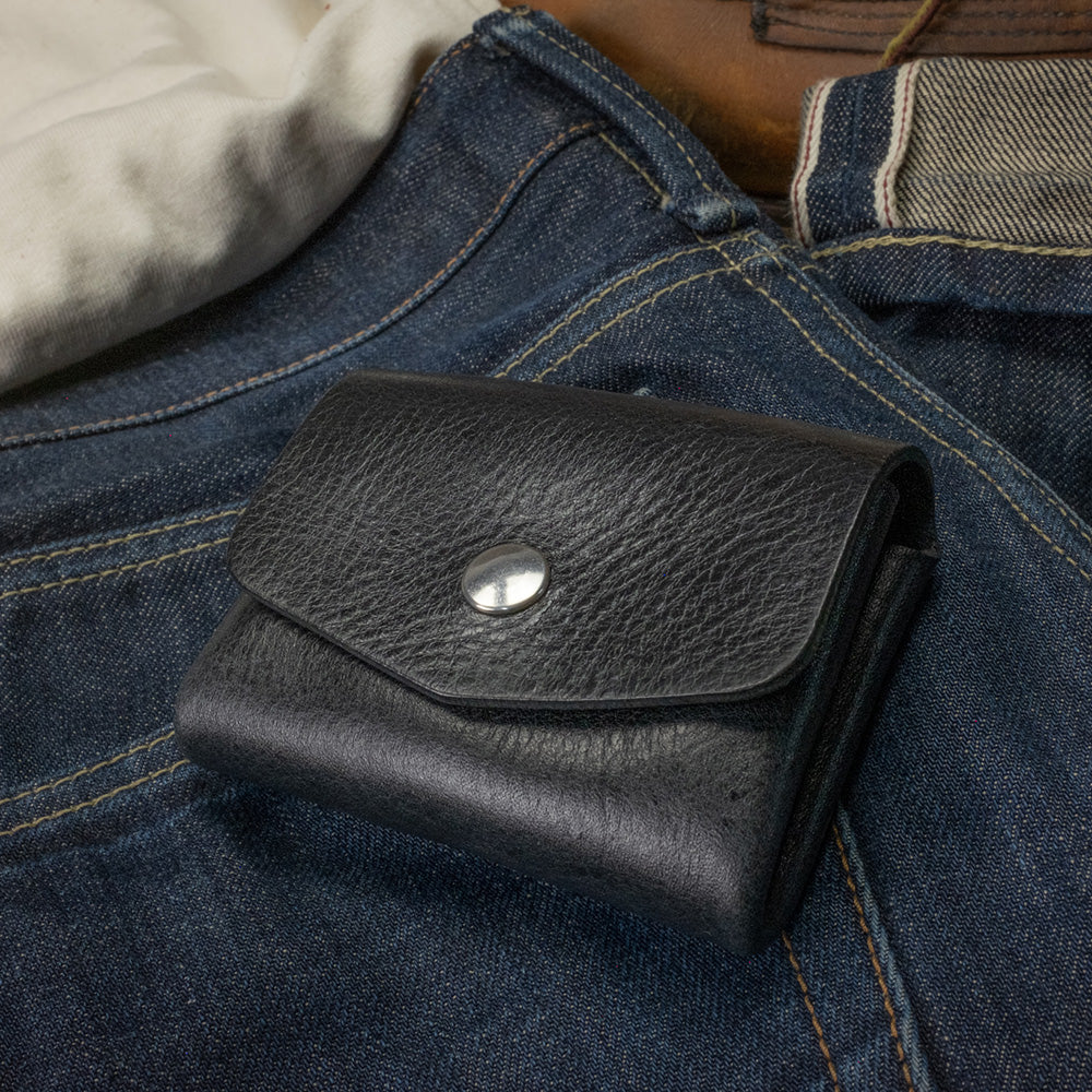 Pocket wallet black top view on denim scene