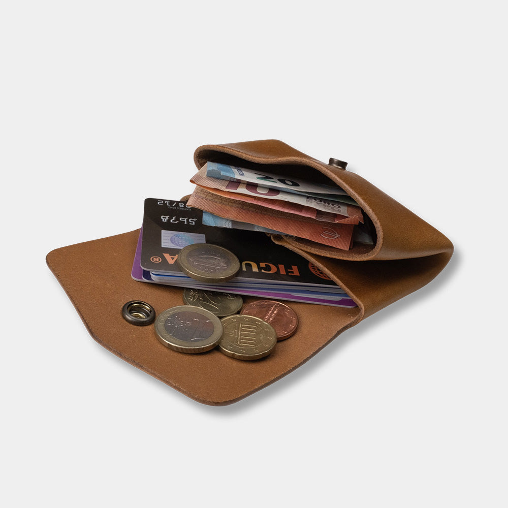 Pocket wallet cognac, open with money and cards, slanted view