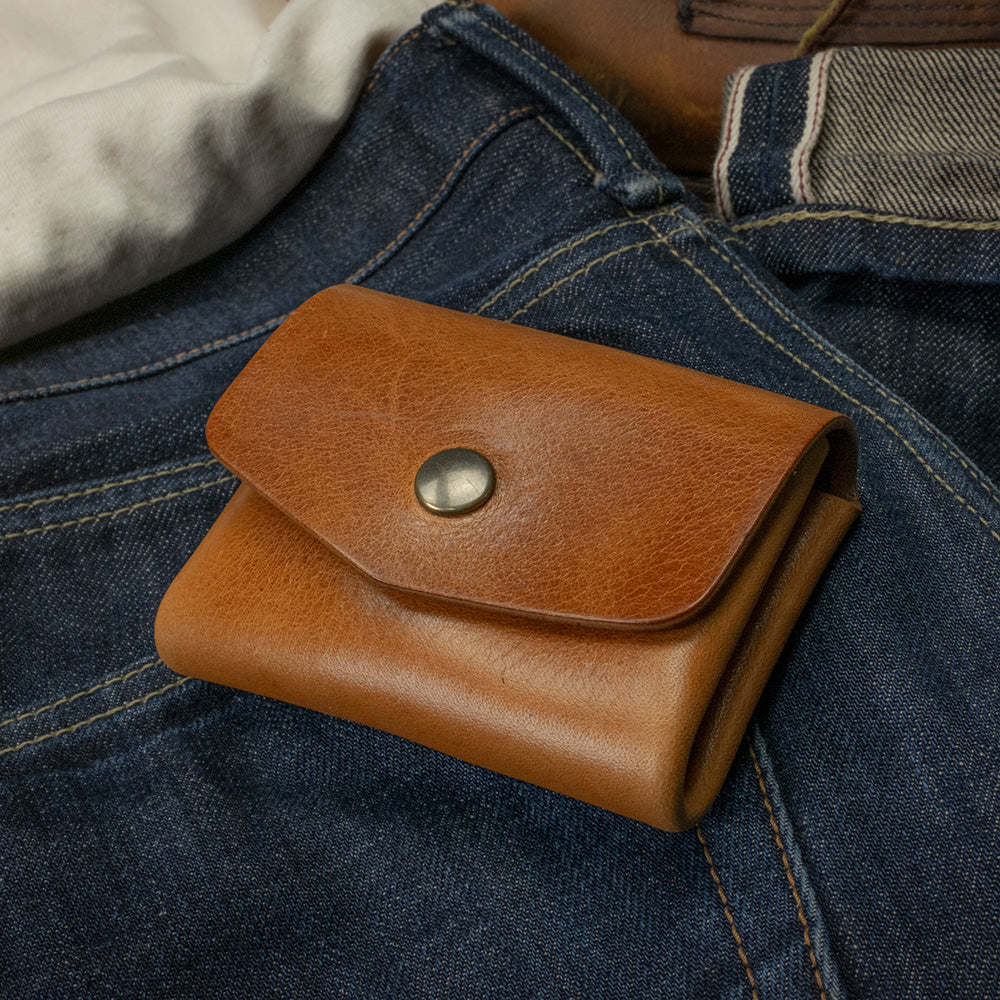 Pocket wallet cognac top view on denim scene