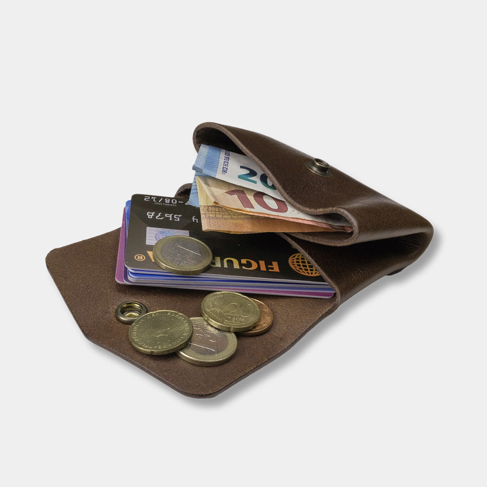 Pocket wallet dark brown, open with money and cards, slanted view