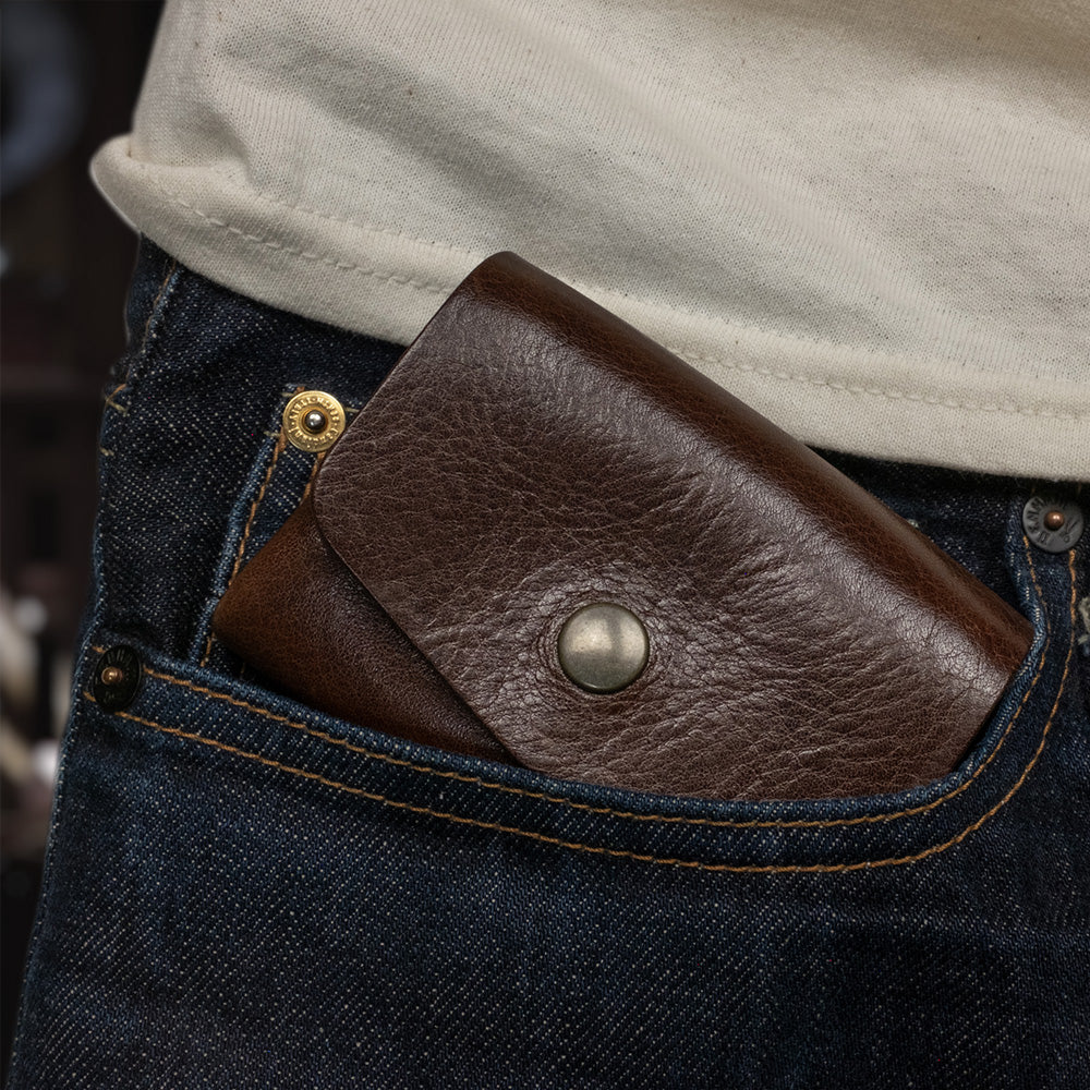 Pocket wallet dark brown in jeans pocket front