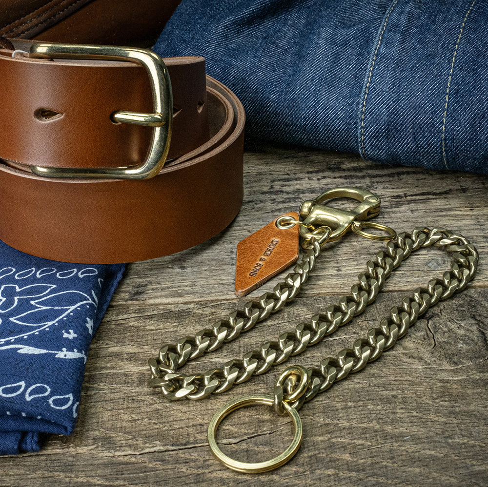 solid brass keychain with Swedish nautical shackle and cognac leather diamond charm on bandana with leather beltc scene 2