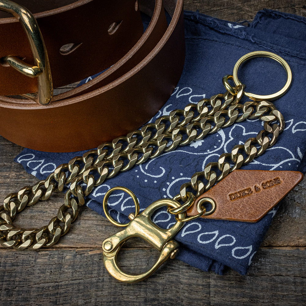 solid brass keychain with Swedish nautical shackle and cognac leather diamond charm on bandana with leather beltc scene