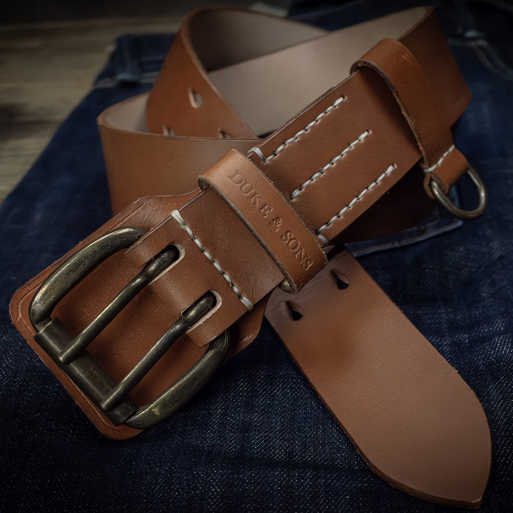 Heavy Duty leather belt in cognac crossed on jeans front, Duke & Sons Leather