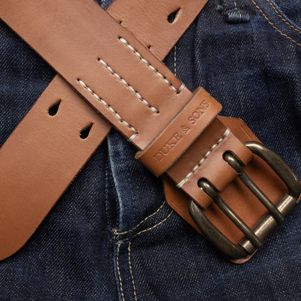 Heavy Duty leather belt in cognac crossed on jeans, Duke & Sons Leather