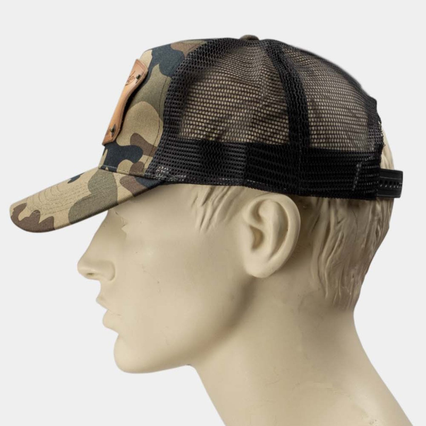 wearing Camo trucker cap with handmade leather patch side spanner| Duke and Sons Leather