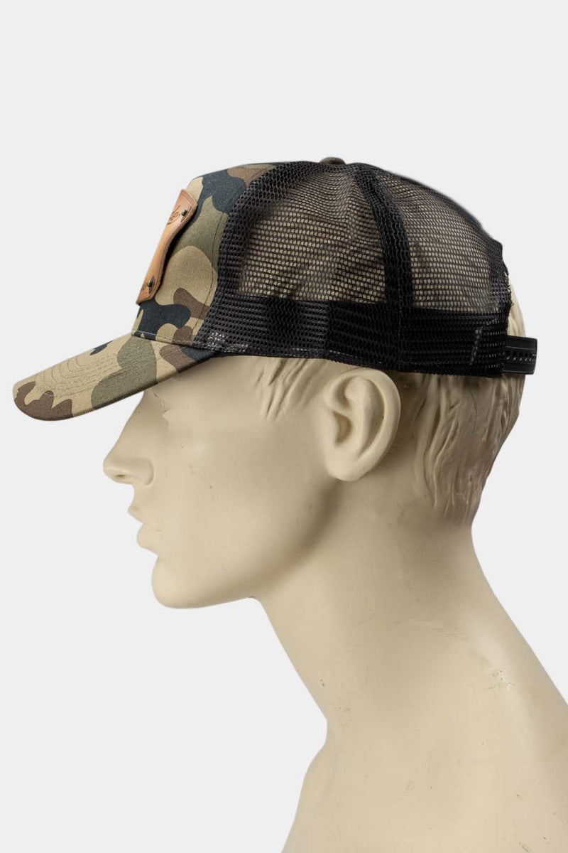 wearing Camo trucker cap with handmade leather patch piston side | Duke and Sons Leather
