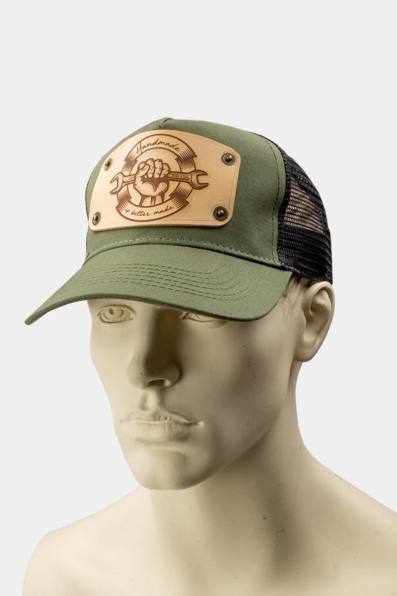 wearing green trucker cap with handmade leather patch spanner front | Duke and Sons Leather
