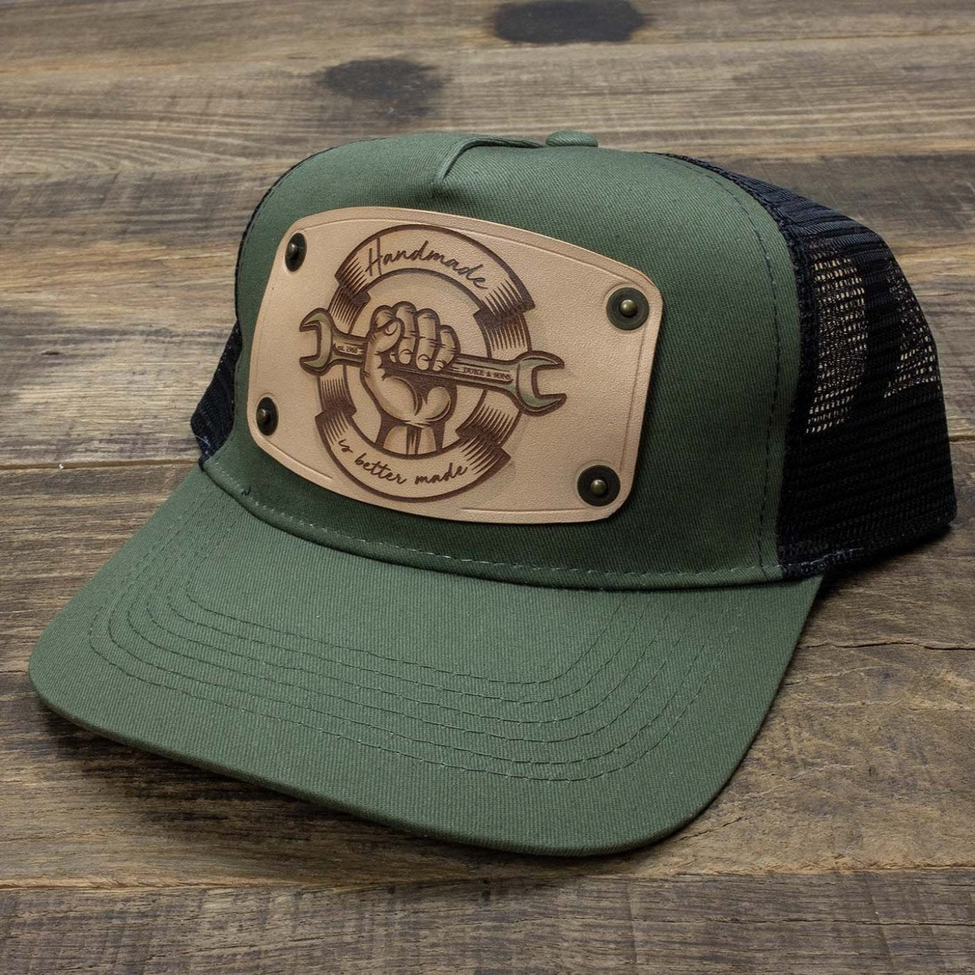 Green trucker cap with handmade leather patch spanner | Duke and Sons Leather