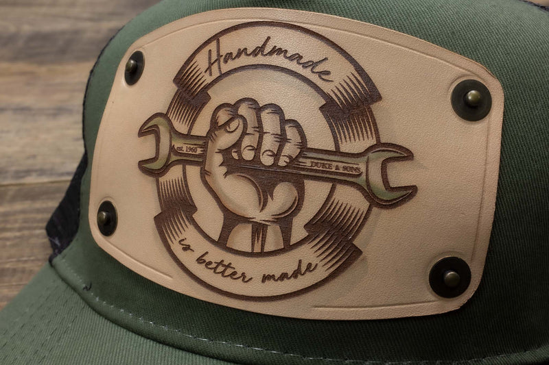 detail Green trucker cap with handmade leather patch spanner | Duke and Sons Leather