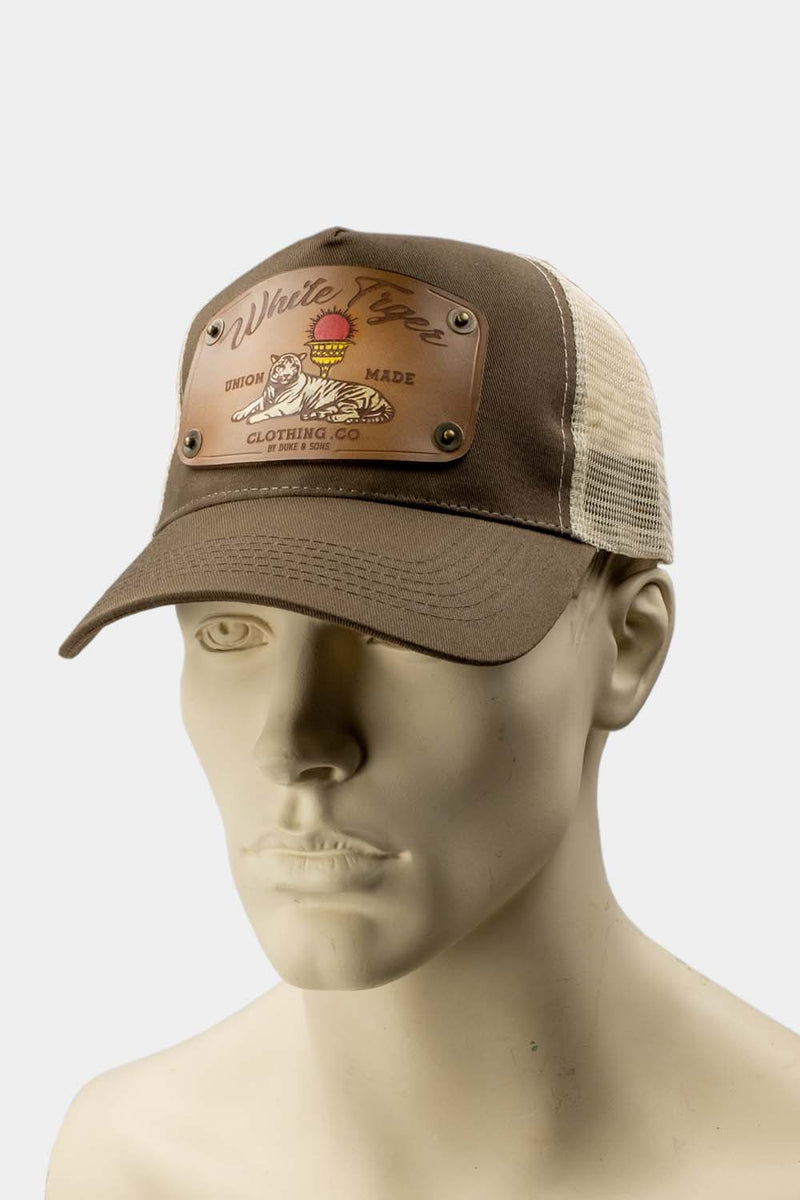 wearing brown trucker cap with handmade leather patch white tiger front | Duke and Sons Leather