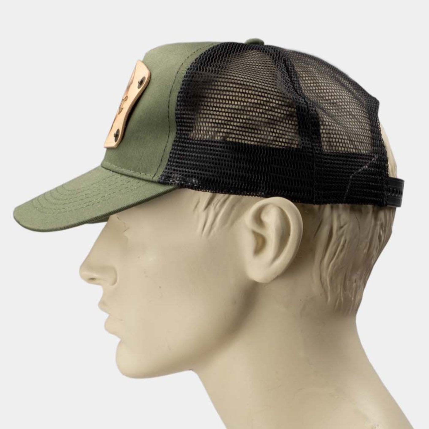 wearing green trucker cap with handmade leather patch spanner side | Duke and Sons Leather