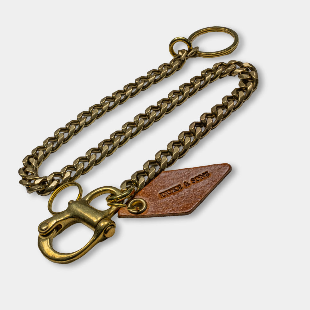 solid brass keychain with Swedish nautical shackle and cognac leather diamond charm top view 2
