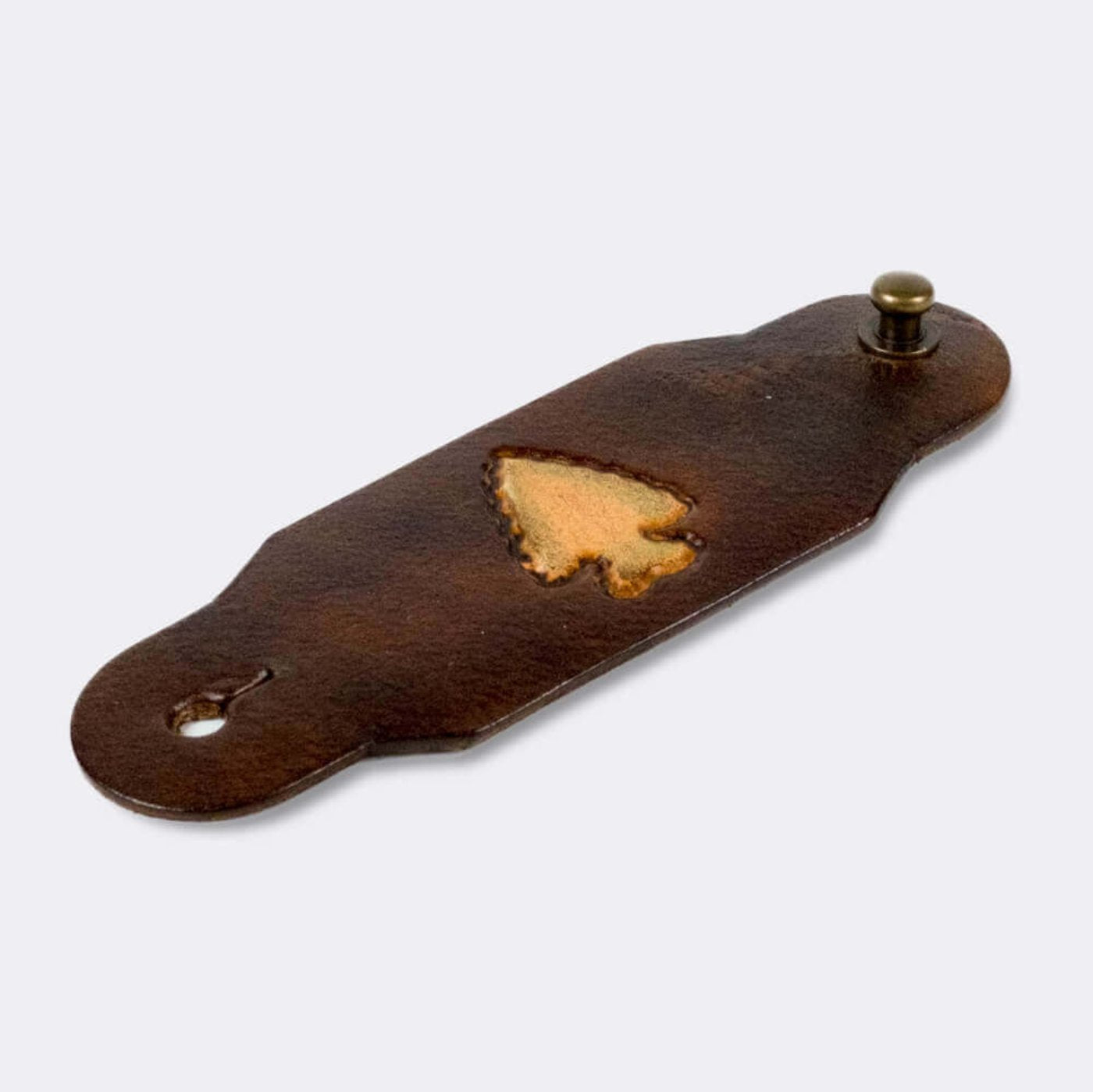 Woggle, bandana / neckerchief slide made from leather with an arrow point image stamp, slanted view