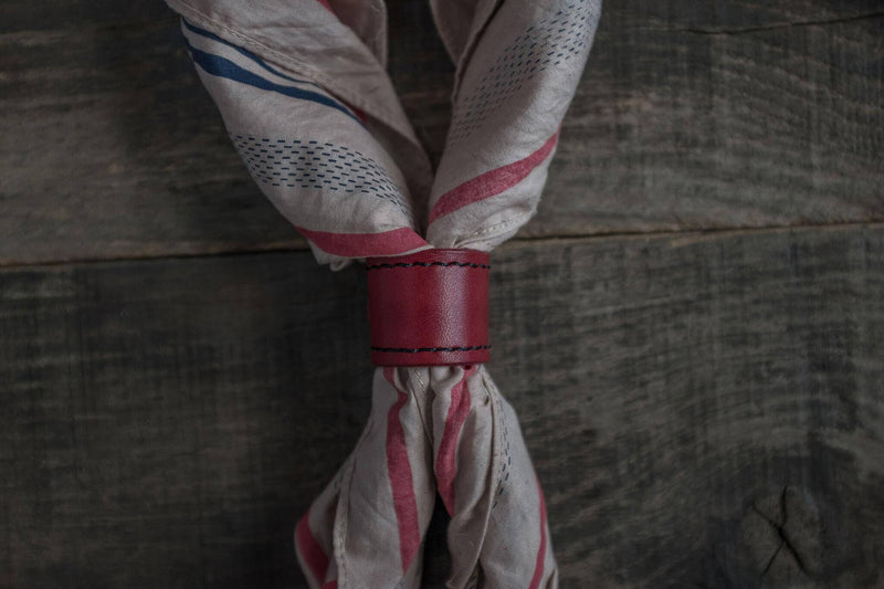 Woggle, bandana / neckerchief slide - in red leather. Duke & Sons Leather, wearing around a bandana