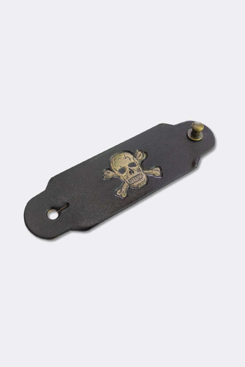 Woggle, bandana / neckerchief slide in black leather with a skull image stamp, slanted view