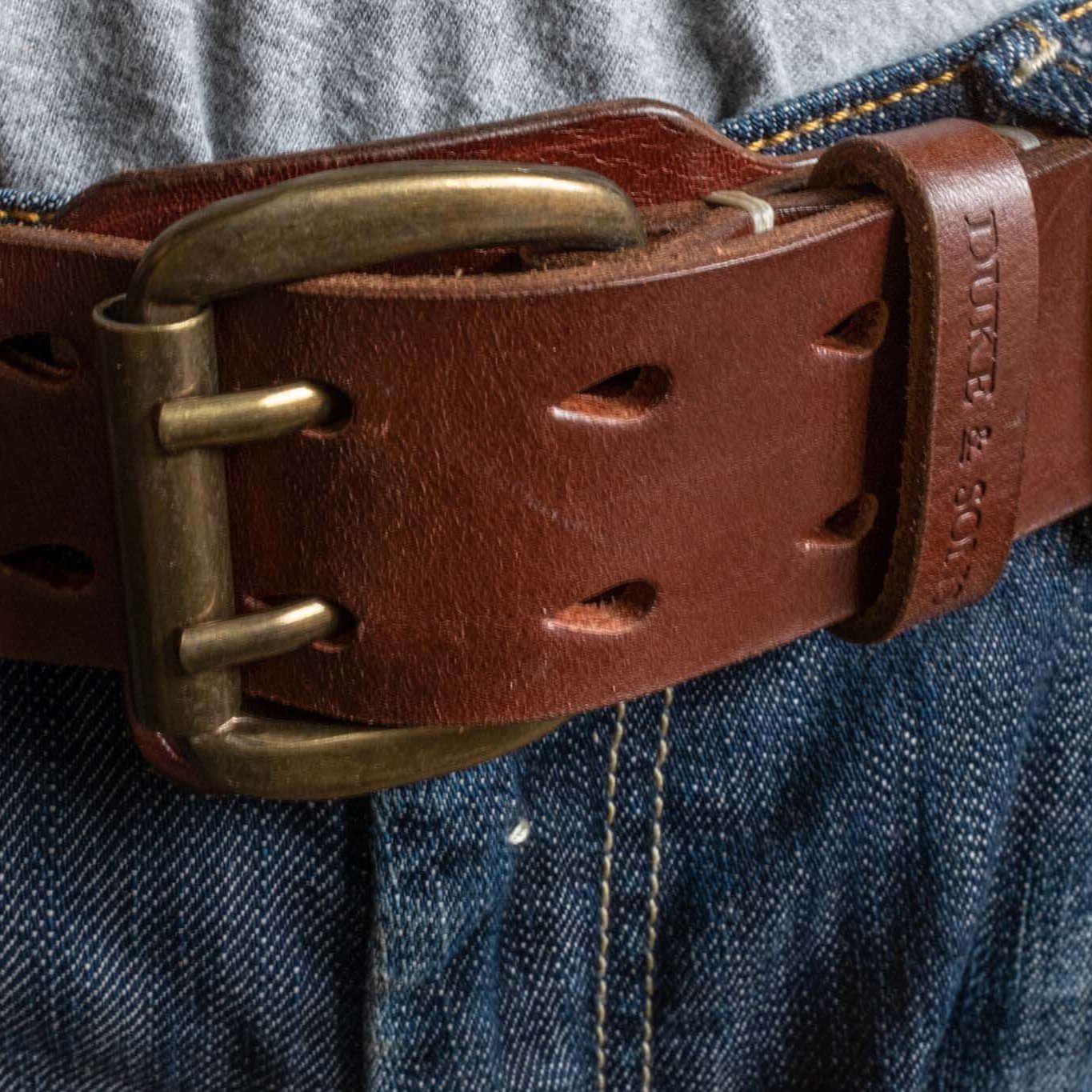 Heavy Duty leather belt in red brown with extra belt loop, wearing on a jeans. Duke & Sons Leather, front view