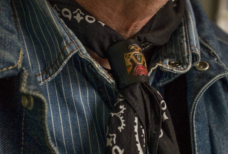 Woggle, bandana / neckerchief slide made from black leather with a native eagle symbol  image stamp, wearing  around a bandana