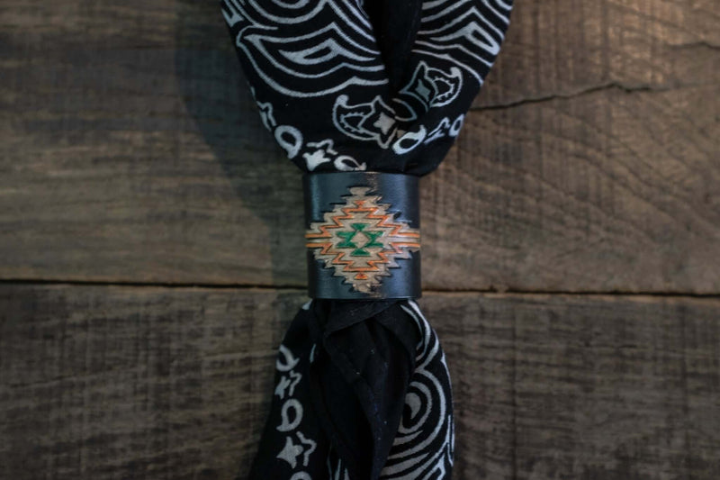 Woggle, bandana / neckerchief slide in black leather with a rectangle native pattern stamp, around a black bandana