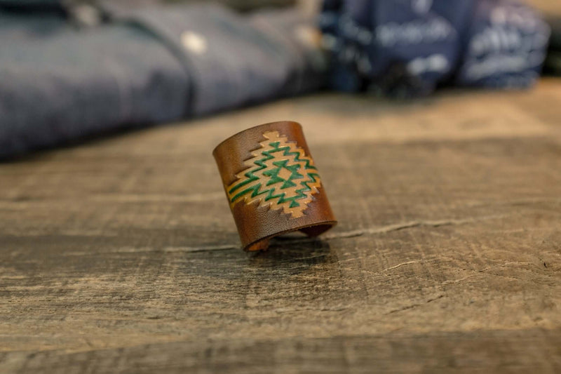 Woggle, bandana / neckerchief slide in cognac leather with a rectangle native pattern stamp, close-up view